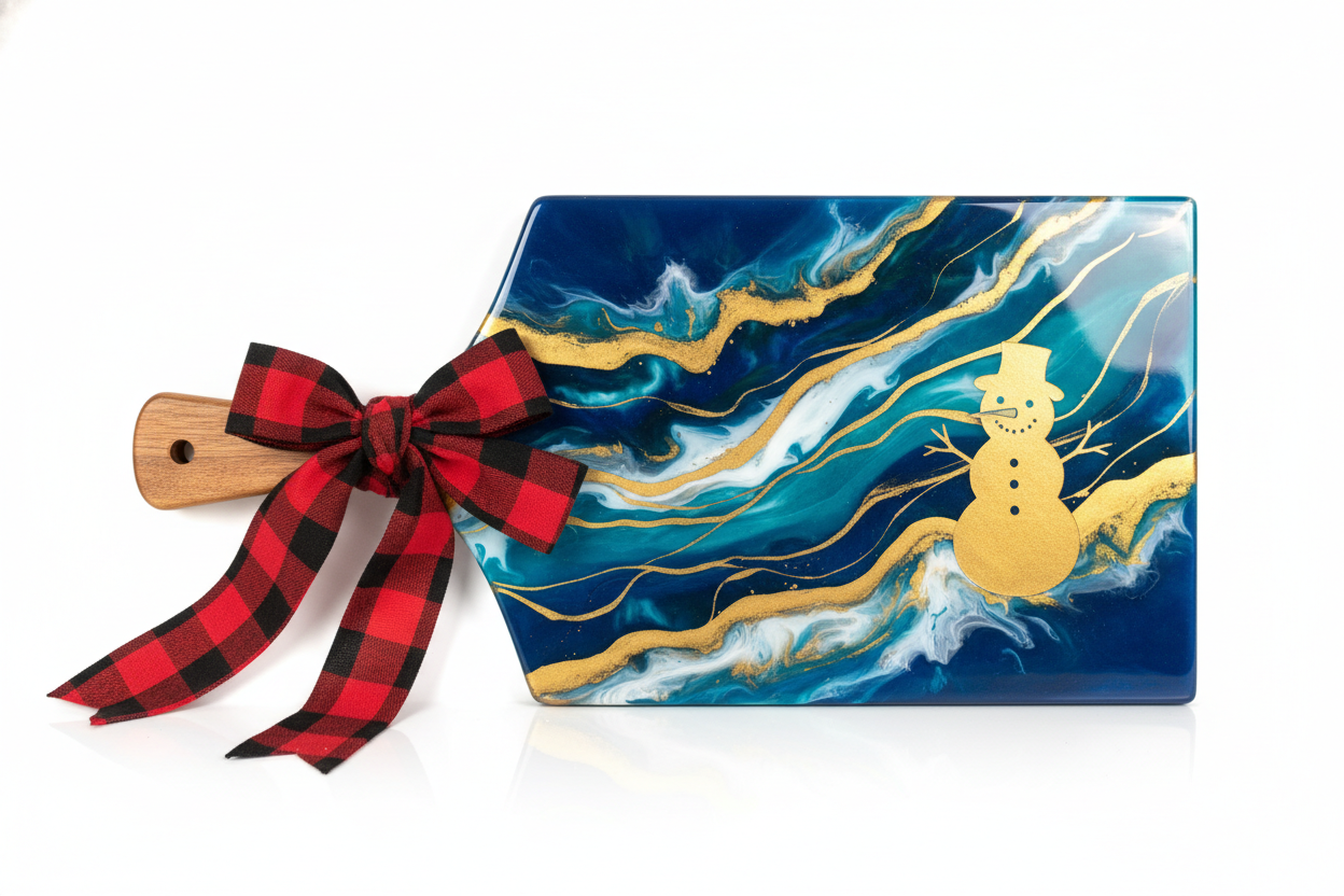 full epoxy cutting board with a flannel bow around the handle  and a gold sillioette of a snow man